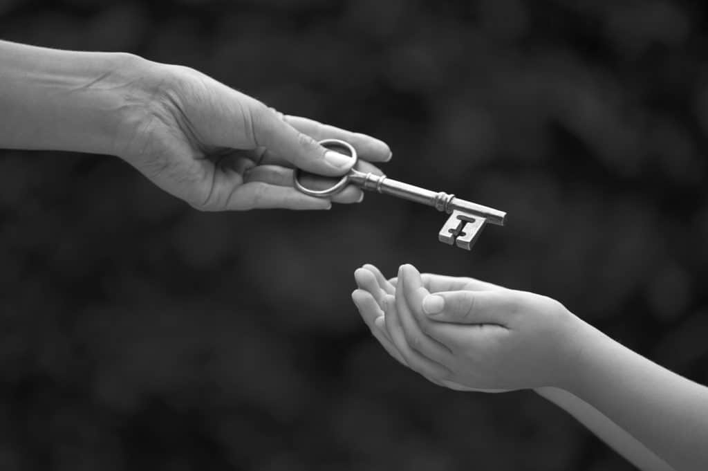 9 Things You Need to Know about Inheriting an HDB Flat in Singapore - 2019 Update featured image - parent handing key over to child