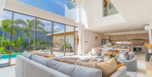 Spacious living area boasts high ceilings and direct access to private pool